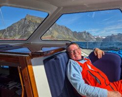Lazy skipper against the backdrop of western Senja